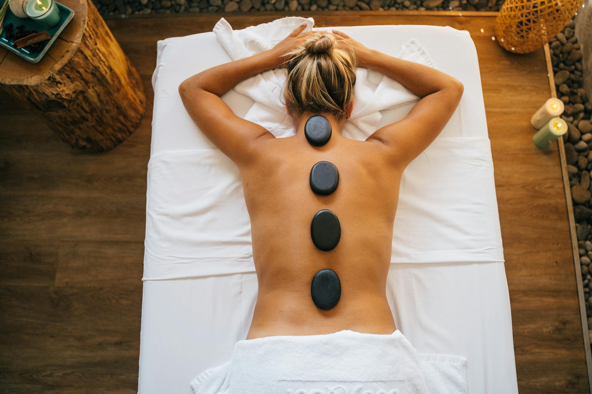 Hot basalt stones placed along the spine — Villa Sage